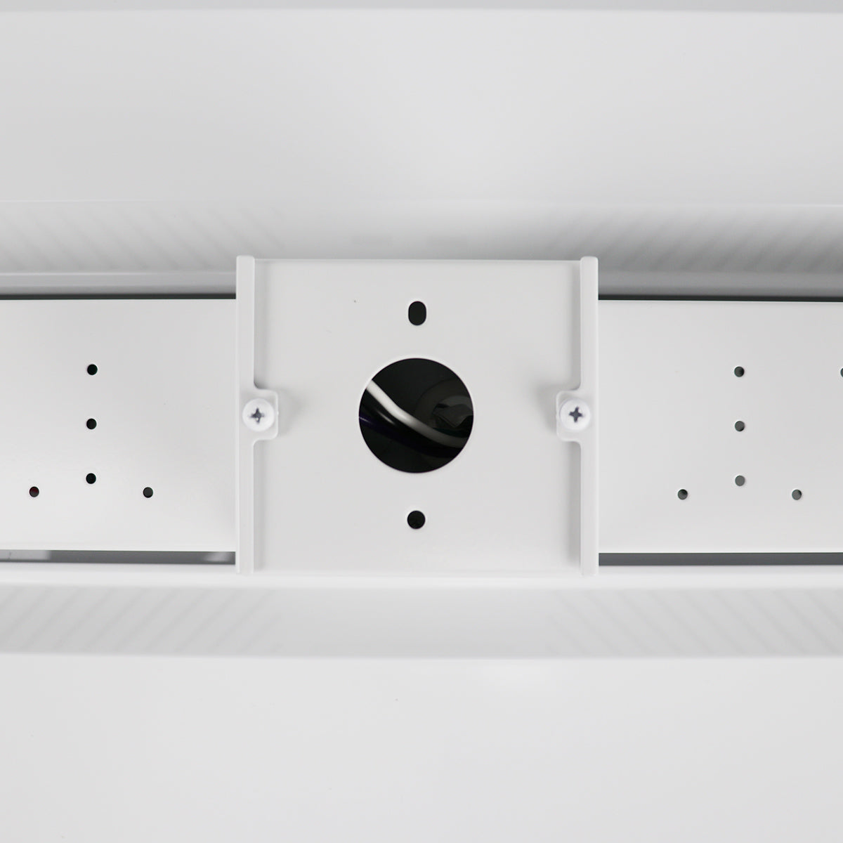 Ceiling light fixture with white cover and black center on a white background