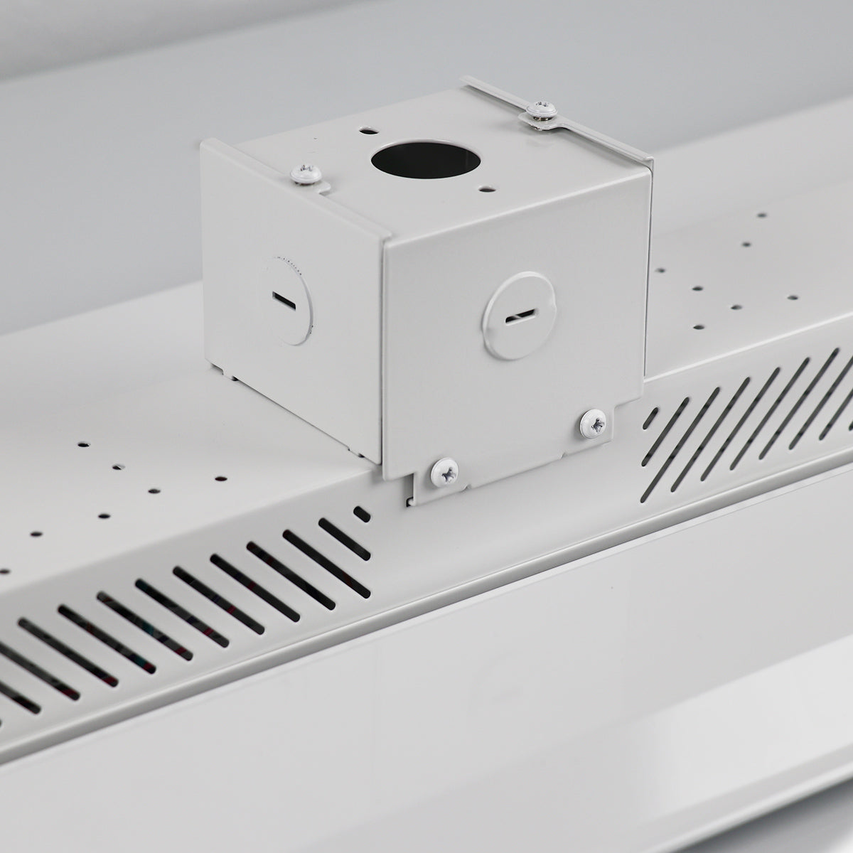 Metallic box with circular cutouts on a white surface